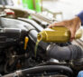 Auto technician performing oil change and brake inspection at a trusted oil change shop Gonzales auto repair service center.
